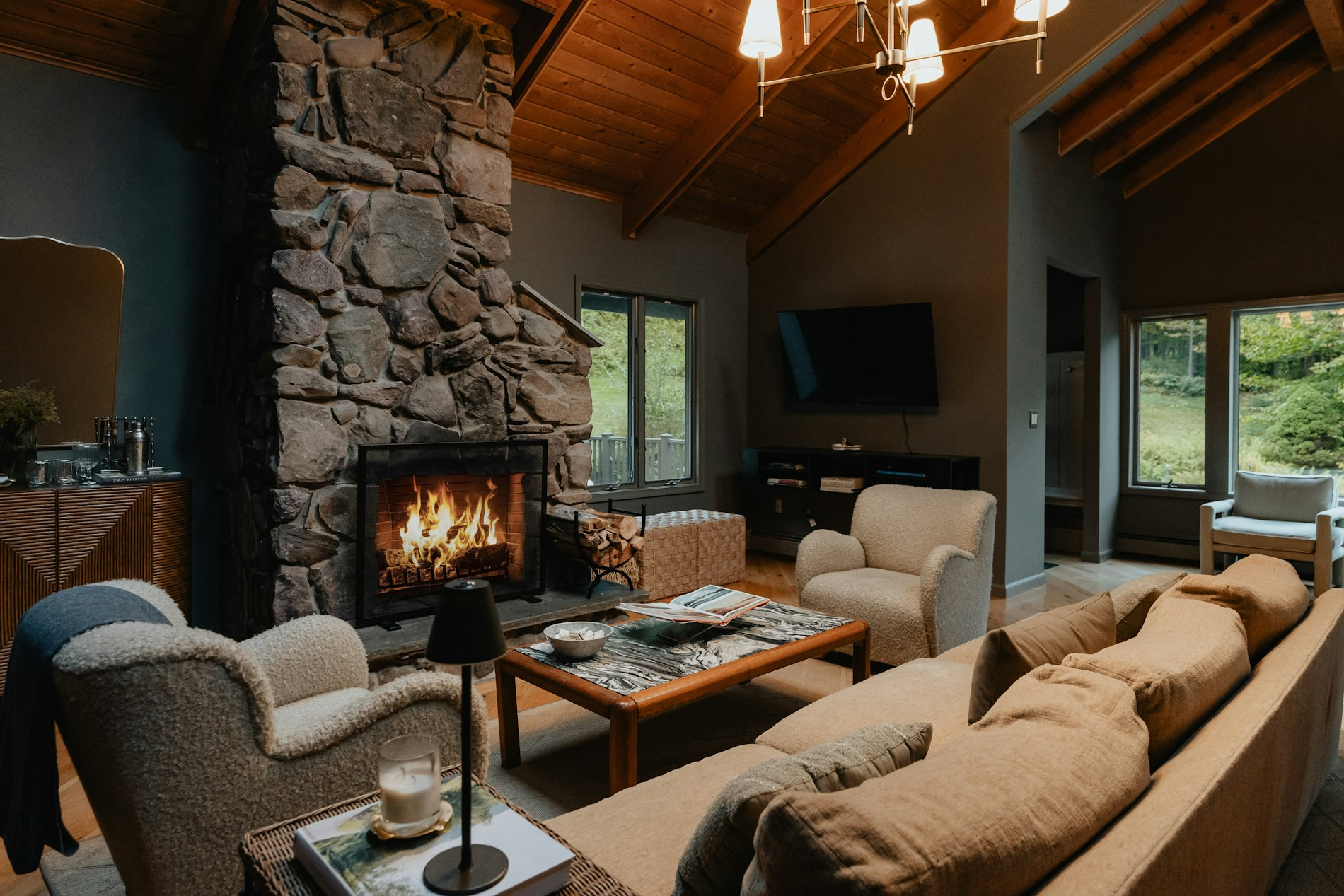Cozy cabin living room with a roaring fireplace